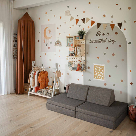 4. Monboxy dark brown play mattress set arranged as a sofa in a colorful children's room