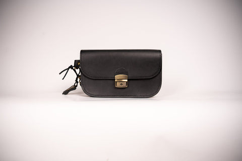 5. Studio shot of black Zelma Kraft natural leather saddle bag mini with buckle closure