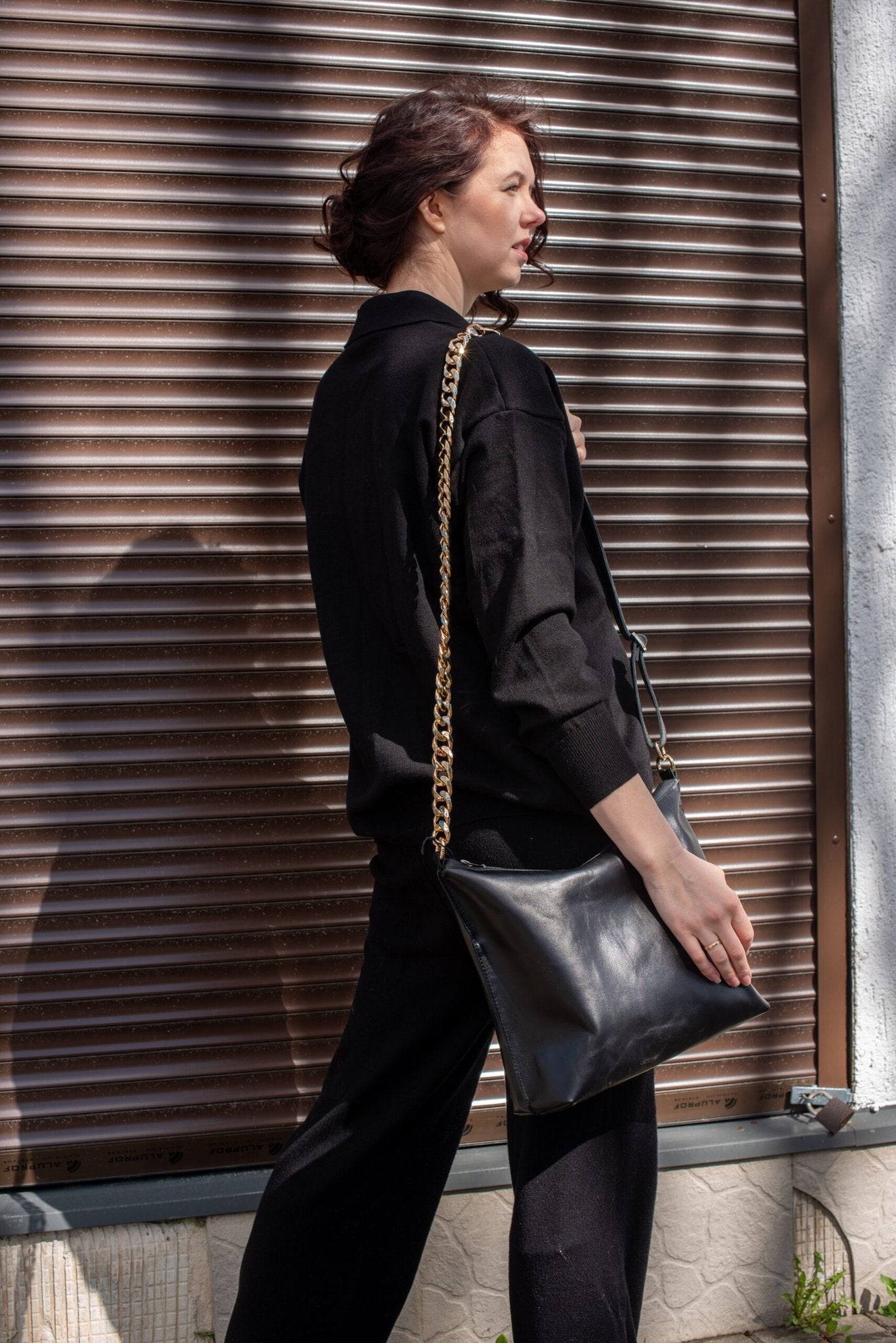10. Close-up of Zelma Kraft black leather hobo bag with silver chain detail