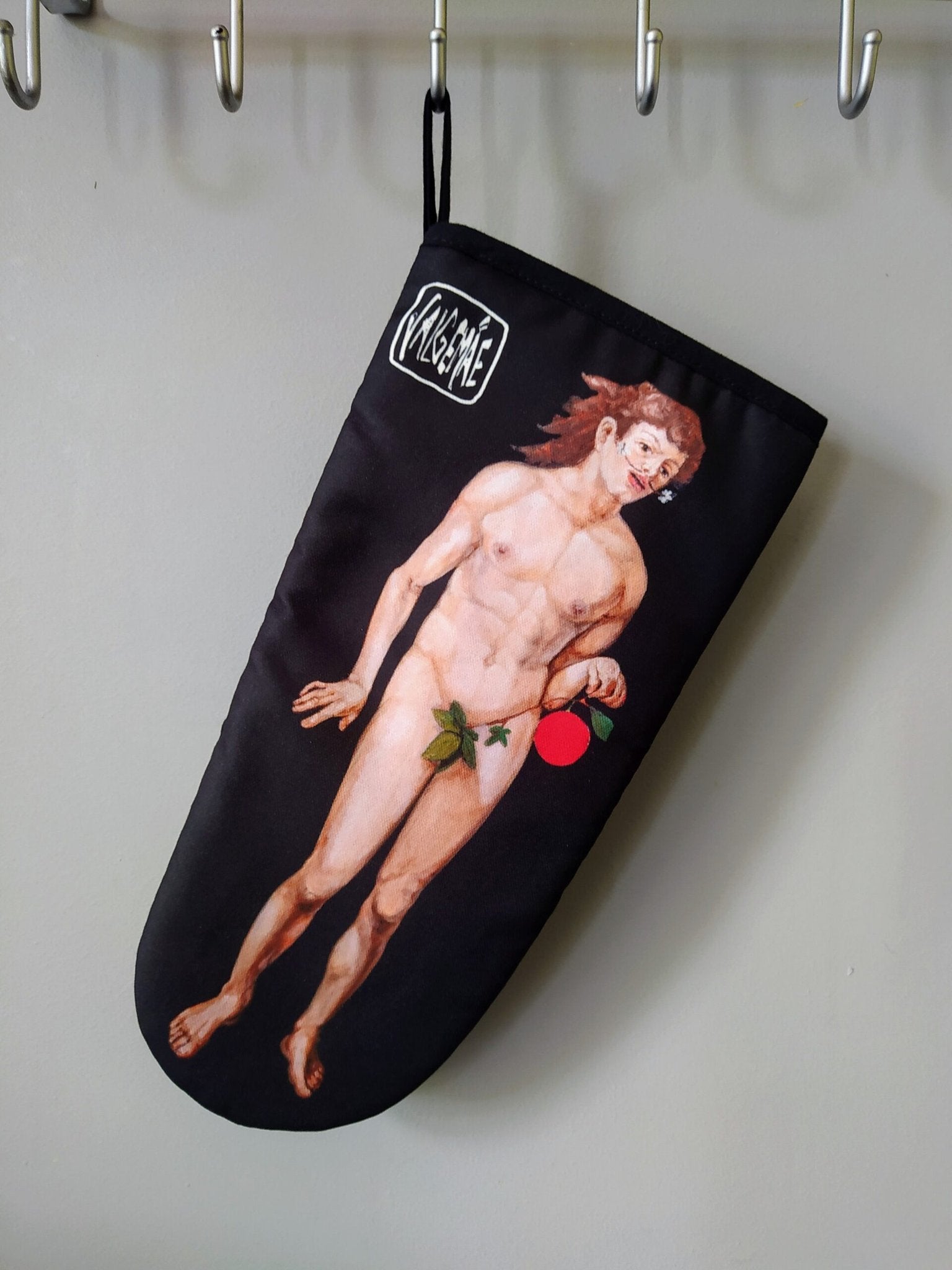 4. Katrin Valgemäe oven glove with Dürer's Adam print hanging on hook, black background