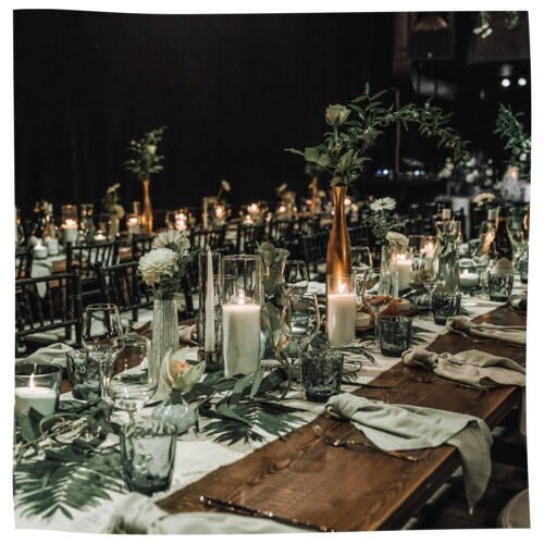 2. Elegant table setting with Candledust powdered candles in glass vases, ideal for weddings and events