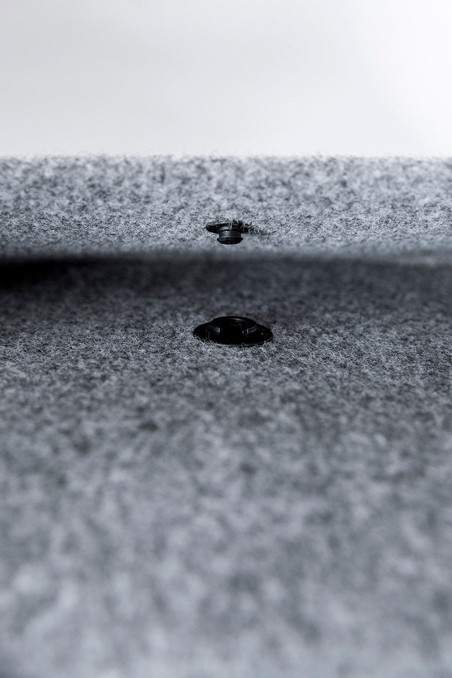 7. Close-up of magnetic snap closure on Nordhale Lund Mini Backpack in grey