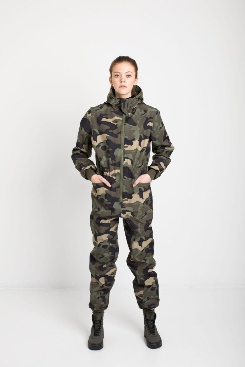 2. Women's SUSANNA softshell overall by Nuckö with hands in pockets, studio setting