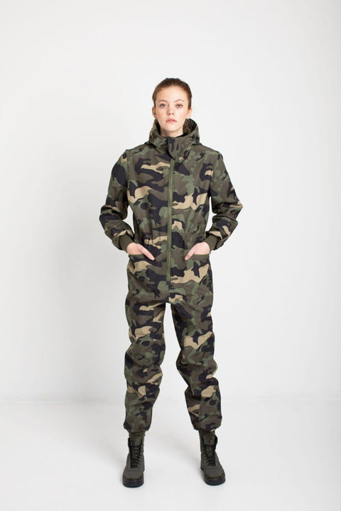 2. Women's SUSANNA softshell overall by Nuckö with hands in pockets, studio setting