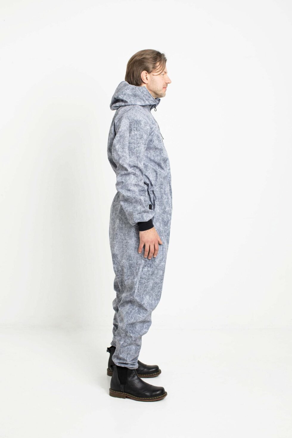 4. Side profile of man in grey Nuckö MEELIS softshell overall, studio background