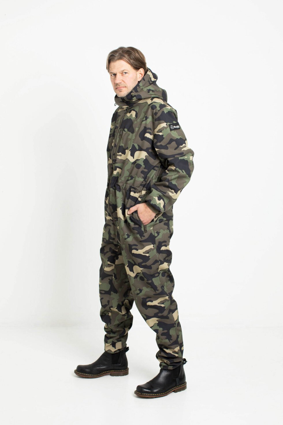 3. Man in Nuckö RINGO softshell overall in camouflage pattern shown from side in studio