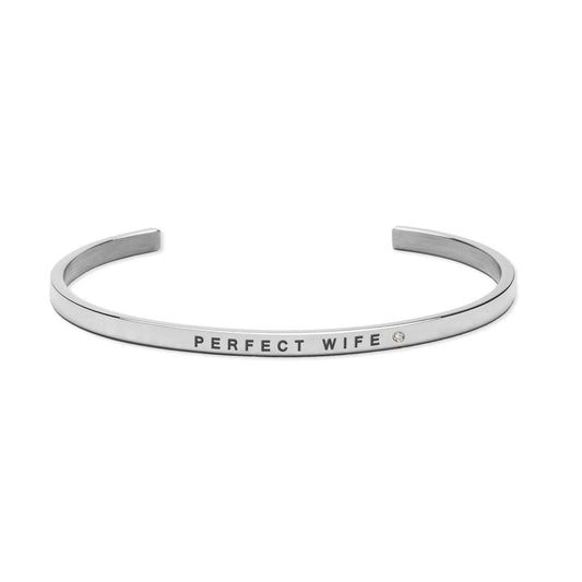 2. Olla Perfect Wife bracelet in polished stainless steel with engraved message, shown in studio