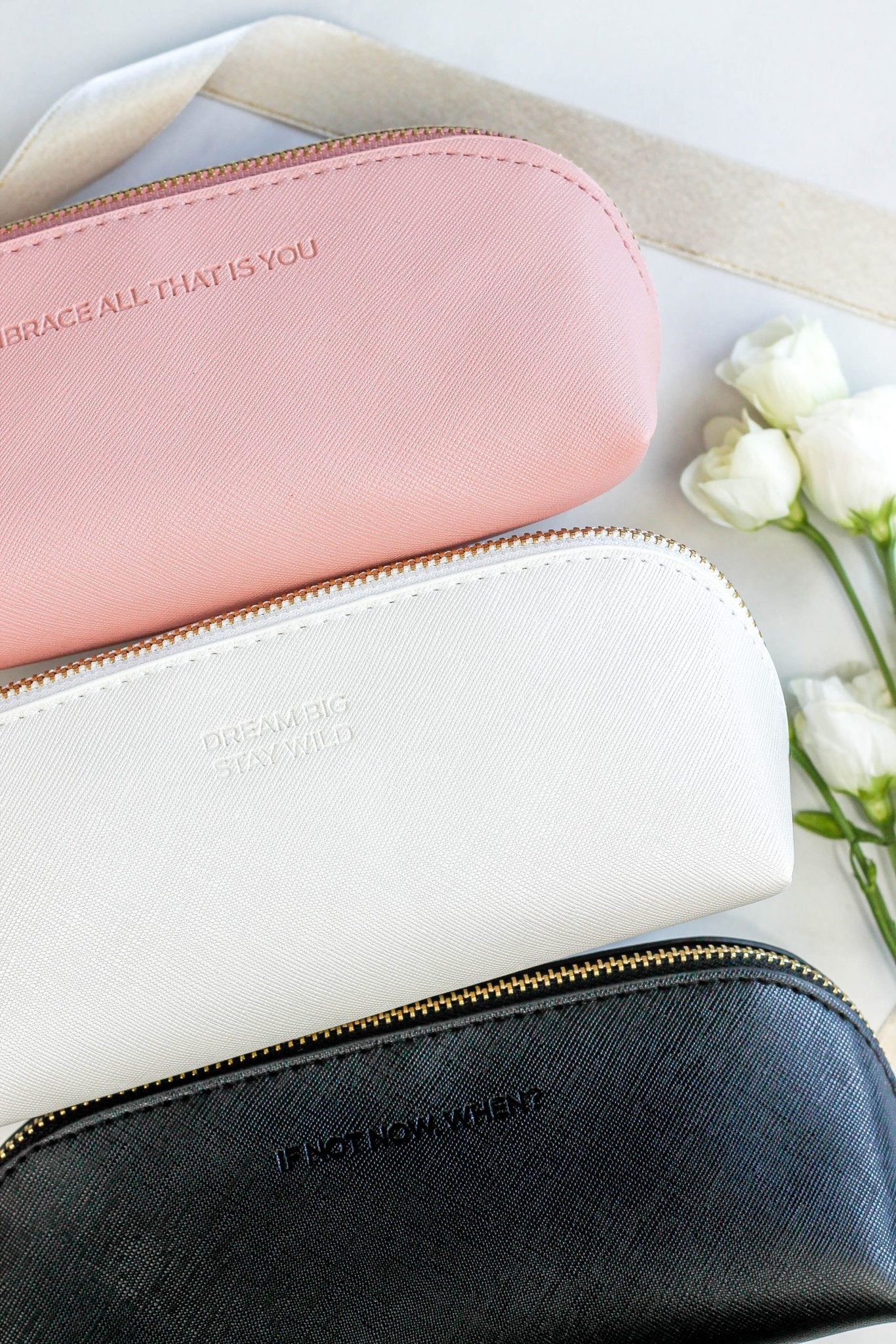 5. Trio of SEIK pencil cases in pink, white, and black with motivational phrases