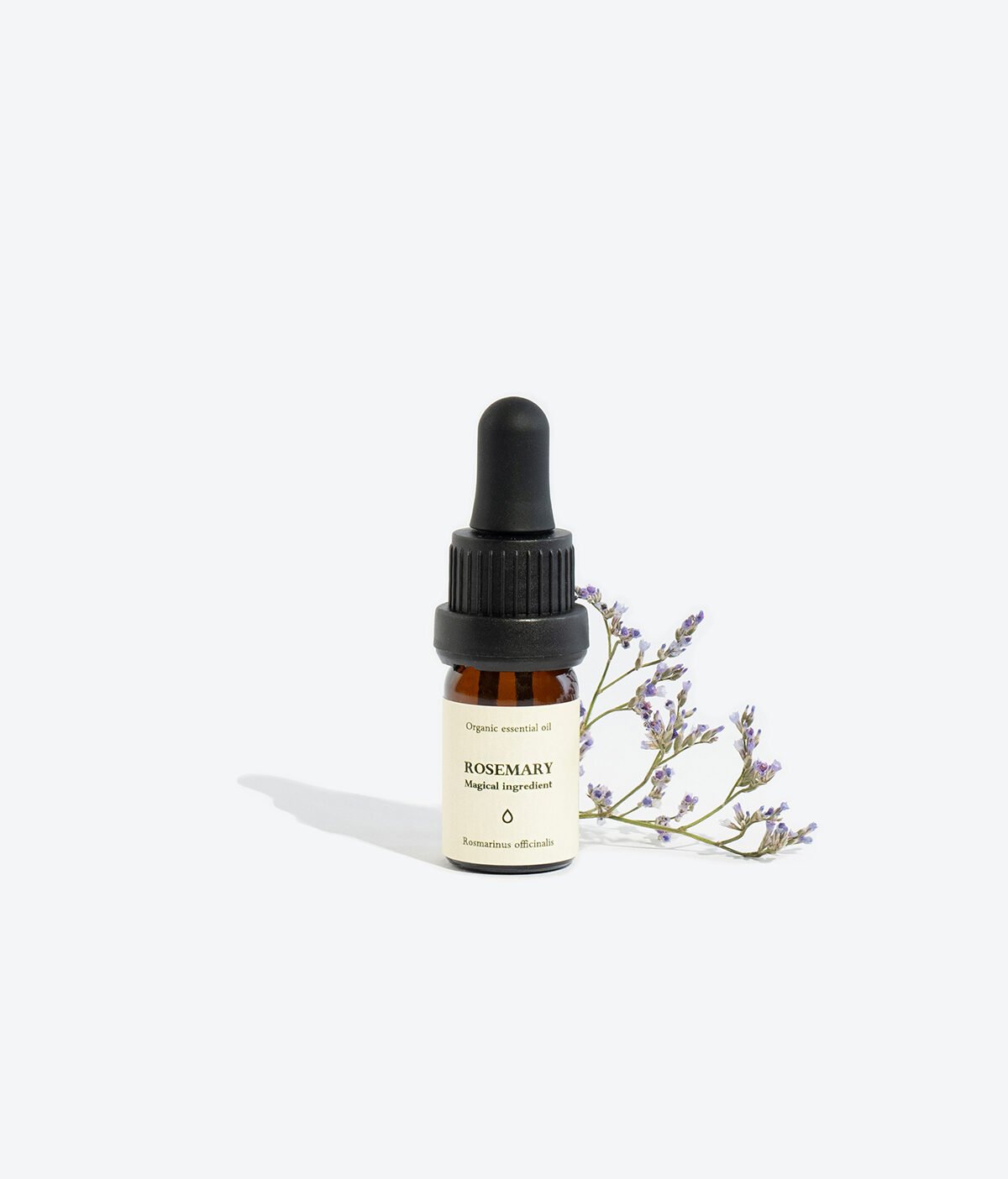 3. Smells Like Spells ROSEMARY Essential Oil in 5 ml glass bottle with pipette, styled with lavender sprig, studio setting