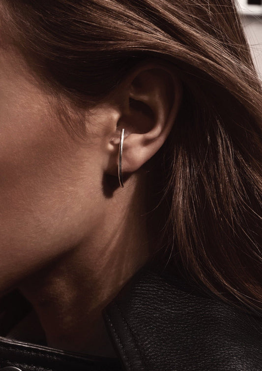 1. Women's silver Radius earrings by NO MORE worn in lifestyle setting, showcasing elegant design