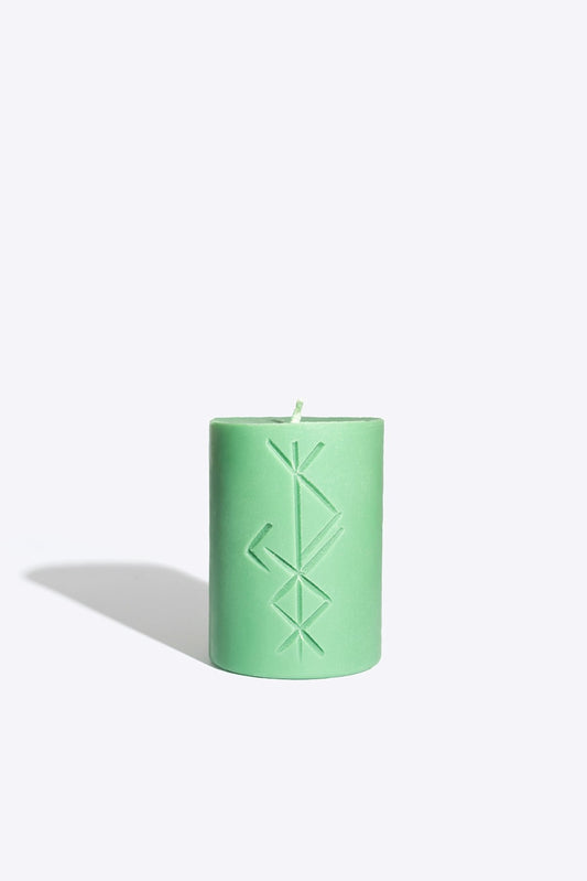2. Studio image of Smells Like Spells Rune candle FREYR in green, highlighting rune design and soy wax