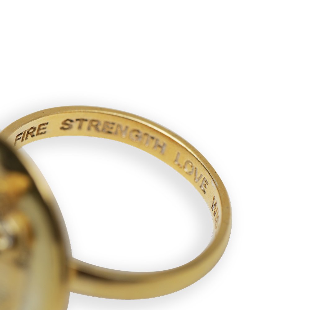 5. Close-up of Sekhmet Fire Necklace Ring in gold by New Vintage by Kriss, showing engraved words 'FIRE STRENGTH LOVE'