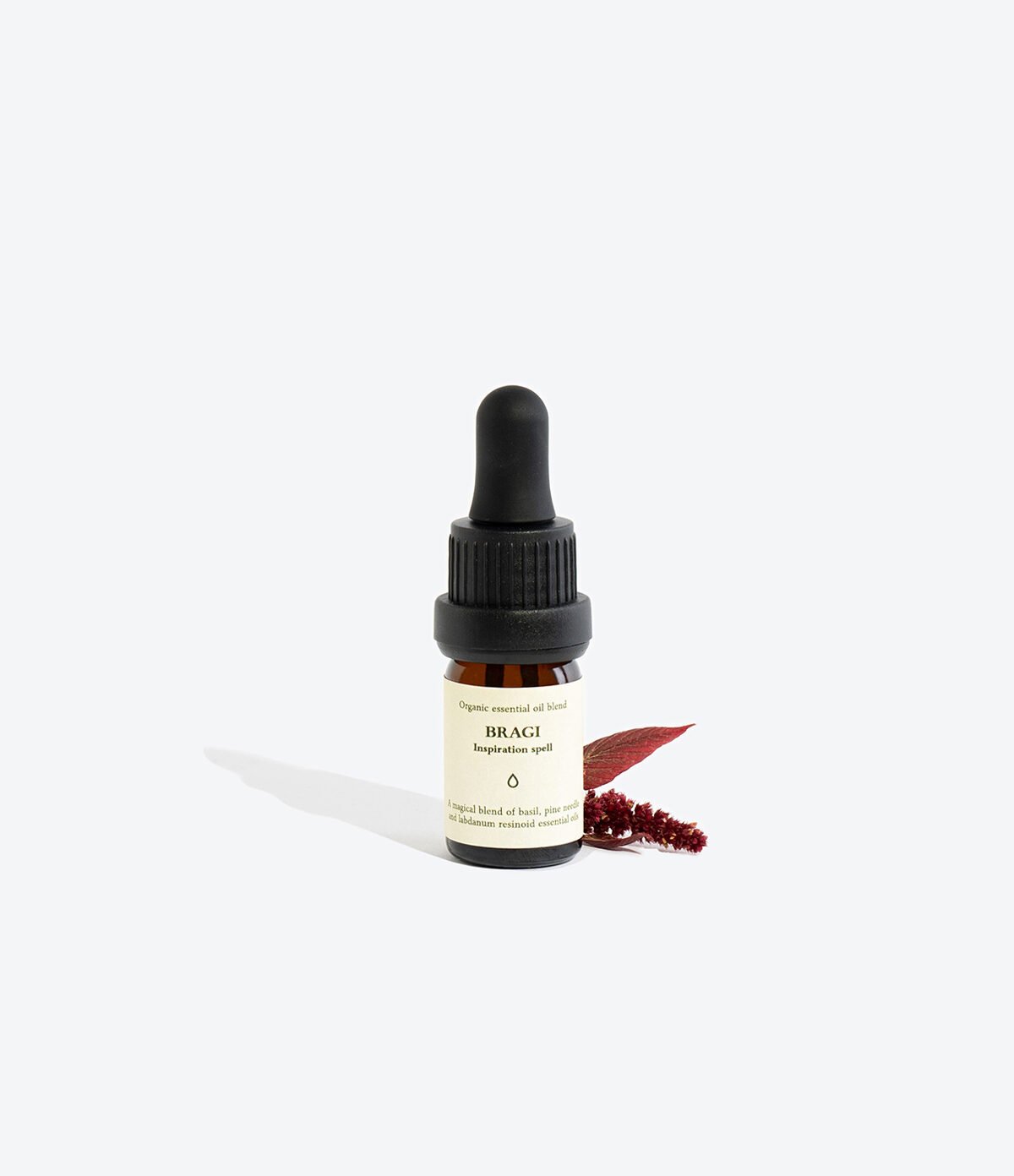 2. Smells Like Spells Essential Oil Blend BRAGI with decorative elements, studio setting
