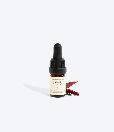 2. Smells Like Spells Essential Oil Blend BRAGI with decorative elements, studio setting