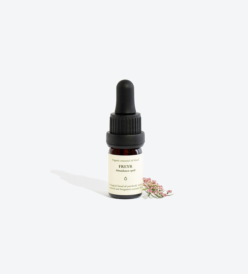 3. Smells Like Spells FREYR essential oil blend dropper bottle with small pink flowers on white background