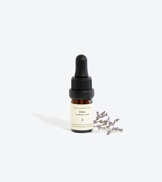 2. Smells Like Spells Essential Oil Blend HAG in 5 ml glass bottle with lavender sprig, studio setting
