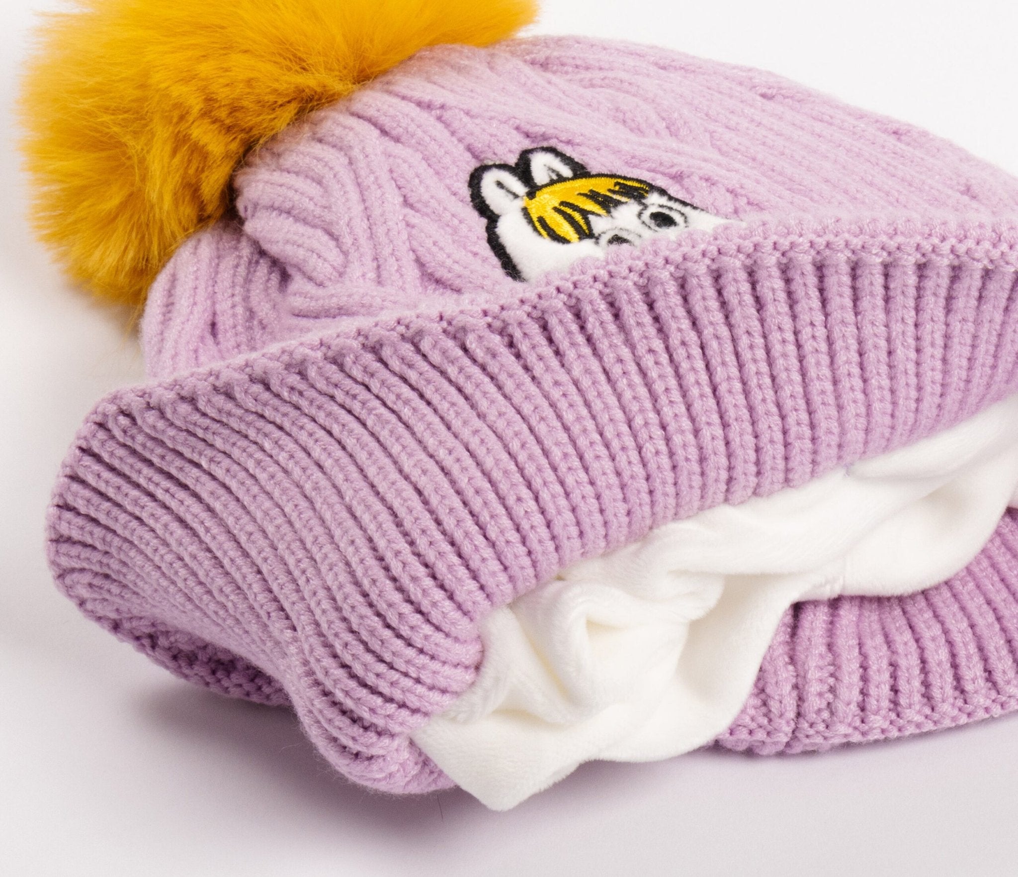 2. Close-up of kids' purple Moomin beanie with yellow pom-pom and fleece lining, folded view