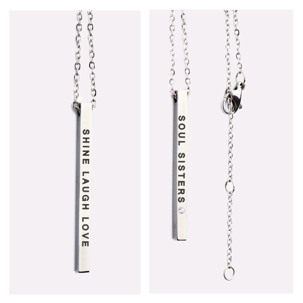 2. Close-up of Olla necklace with double-sided pendant, showing 'SHINE LAUGH LOVE' and 'SOUL SISTERS' engravings in silver