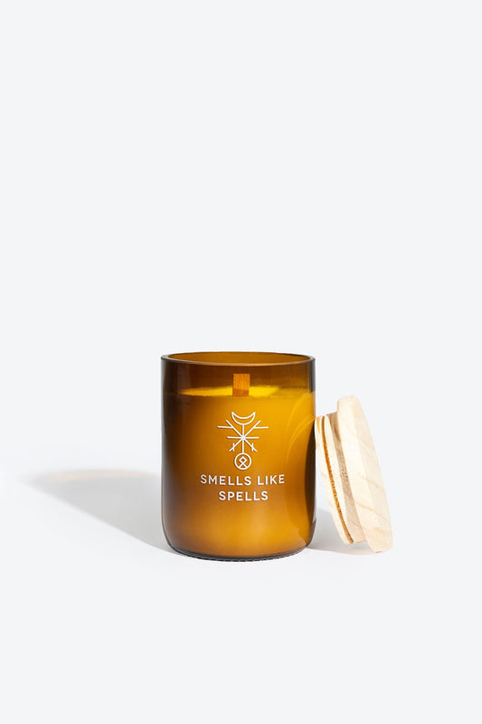 2. Smells Like Spells Scented Candle NORNS in amber glass jar with wooden wick and lid removed, showcasing interior