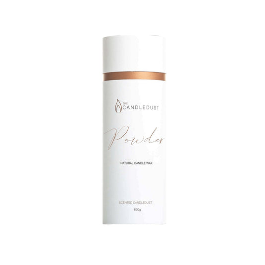 1. Candledust powdered candle in sleek white packaging with copper accent, shown in studio setting