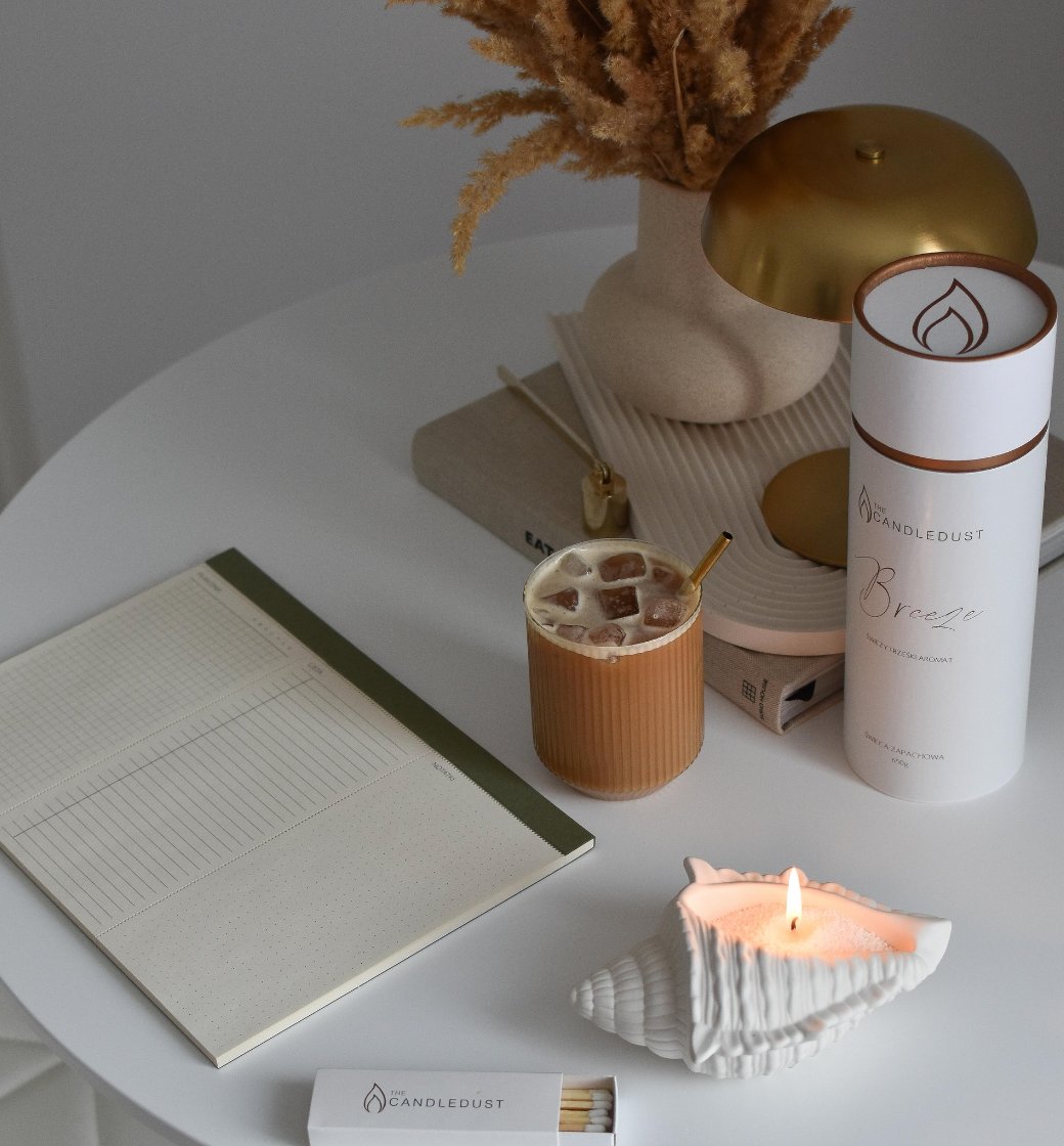 4. Lifestyle setup with Candledust powdered candle, notebook, and coffee on a white table