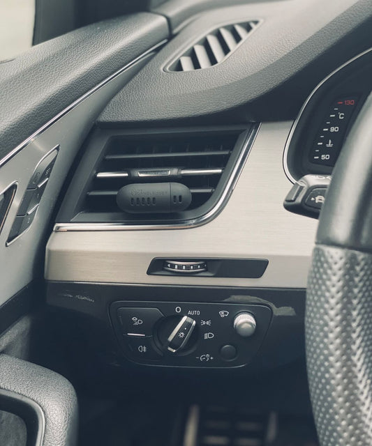 1. Candledust Champagne Rhubarb car diffuser in car interior, showcasing sleek design and vent placement