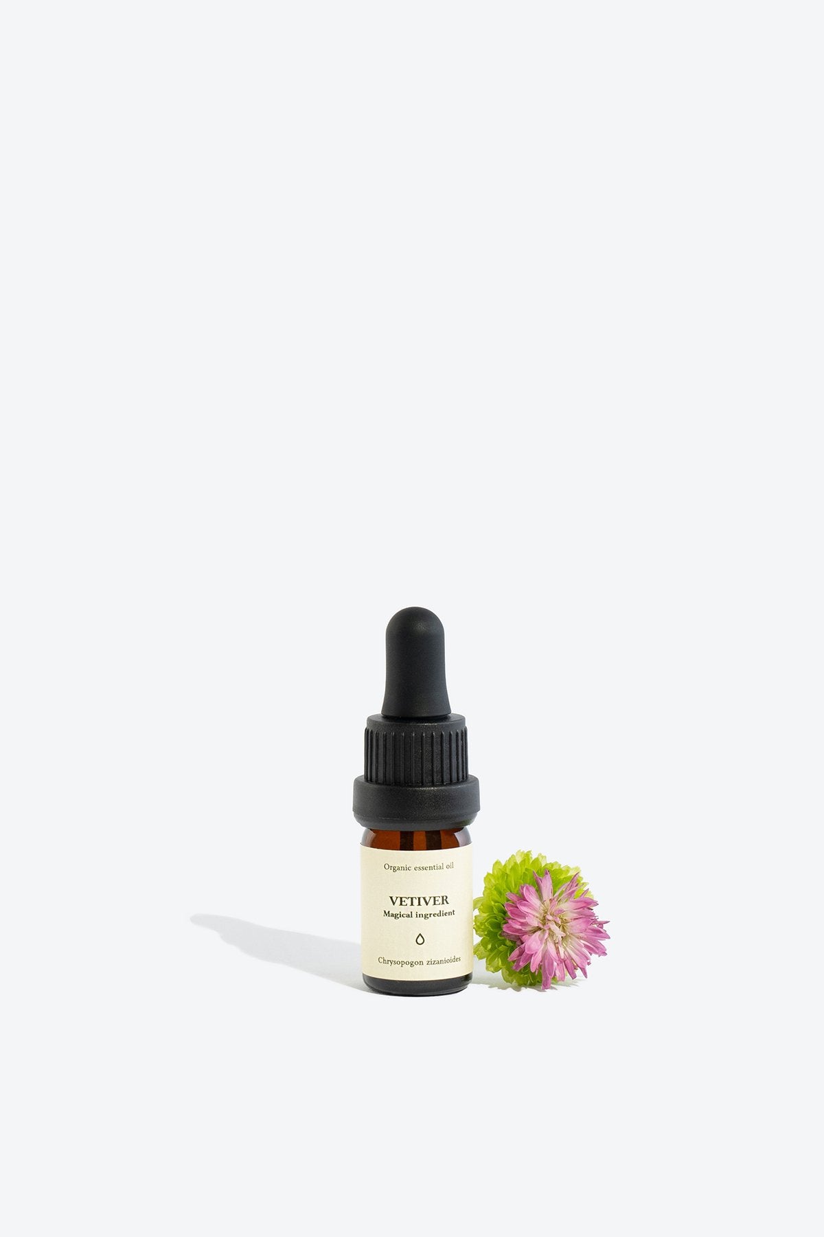 3. Smells Like Spells VETIVER Essential Oil bottle with flower accent, studio setting