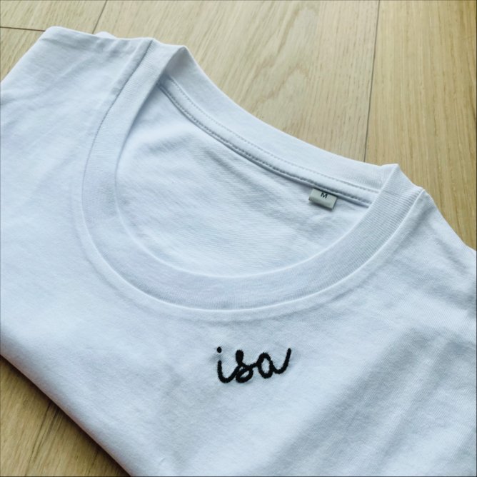 4. Unisex black organic cotton T-shirt by Beebila worn by male model, showcasing embroidered collar in studio setting