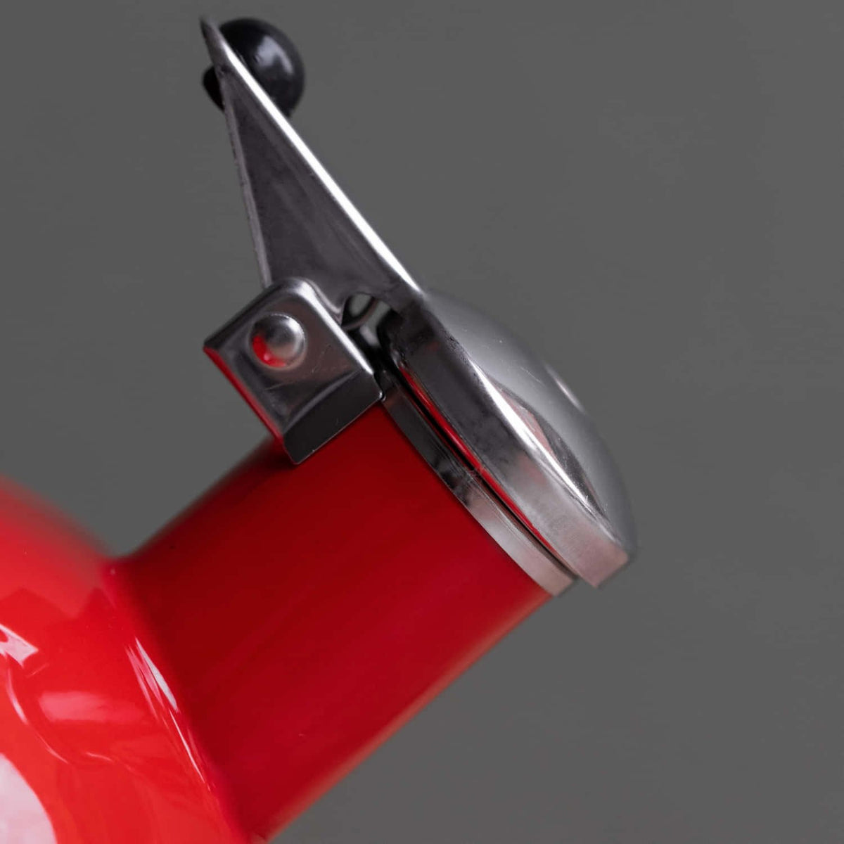 3. Close-up of stainless steel spout and whistle mechanism on red La Cafetière kettle
