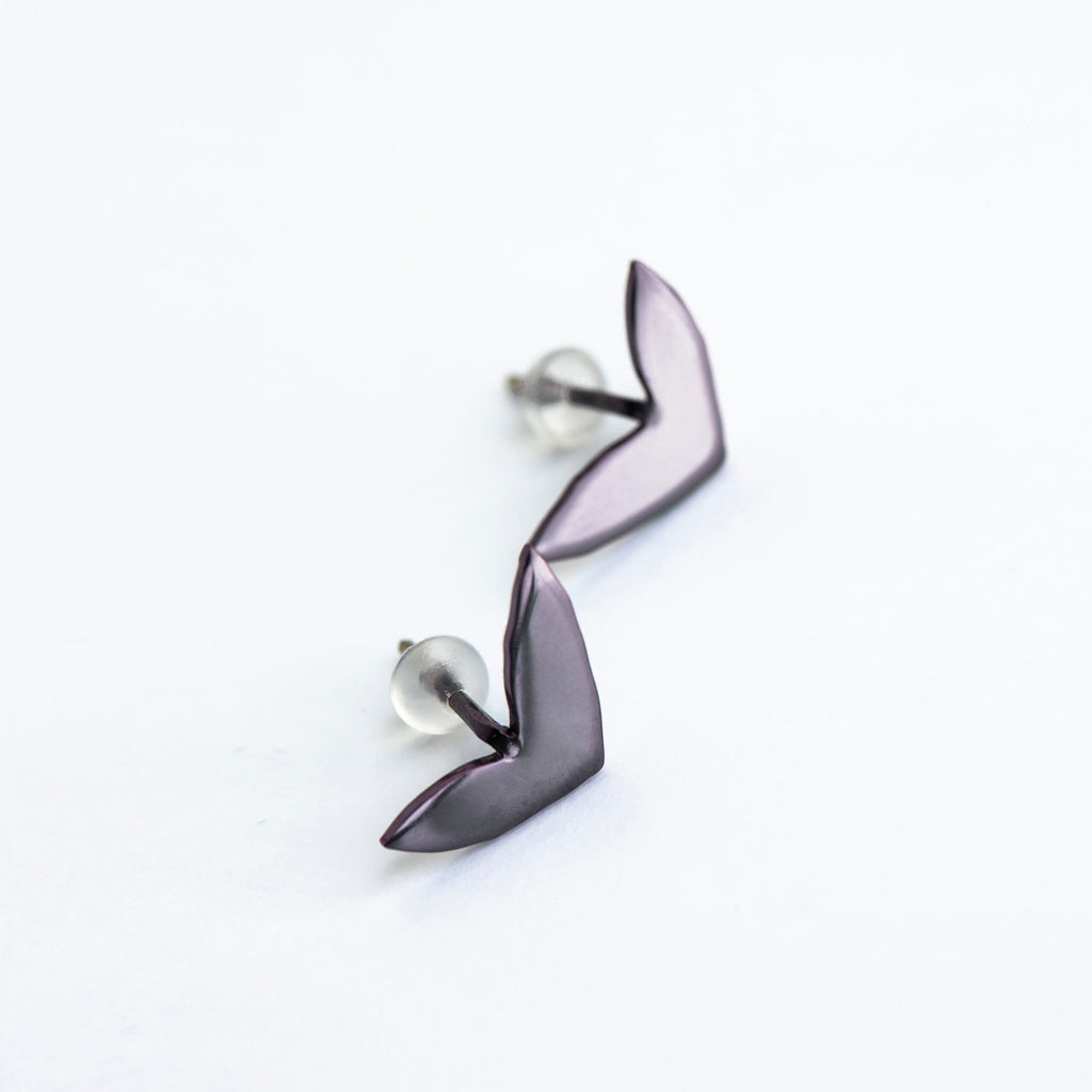 7. Studio shot of Lentsius Vola purple earrings with silicone stoppers, crafted from upcycled materials