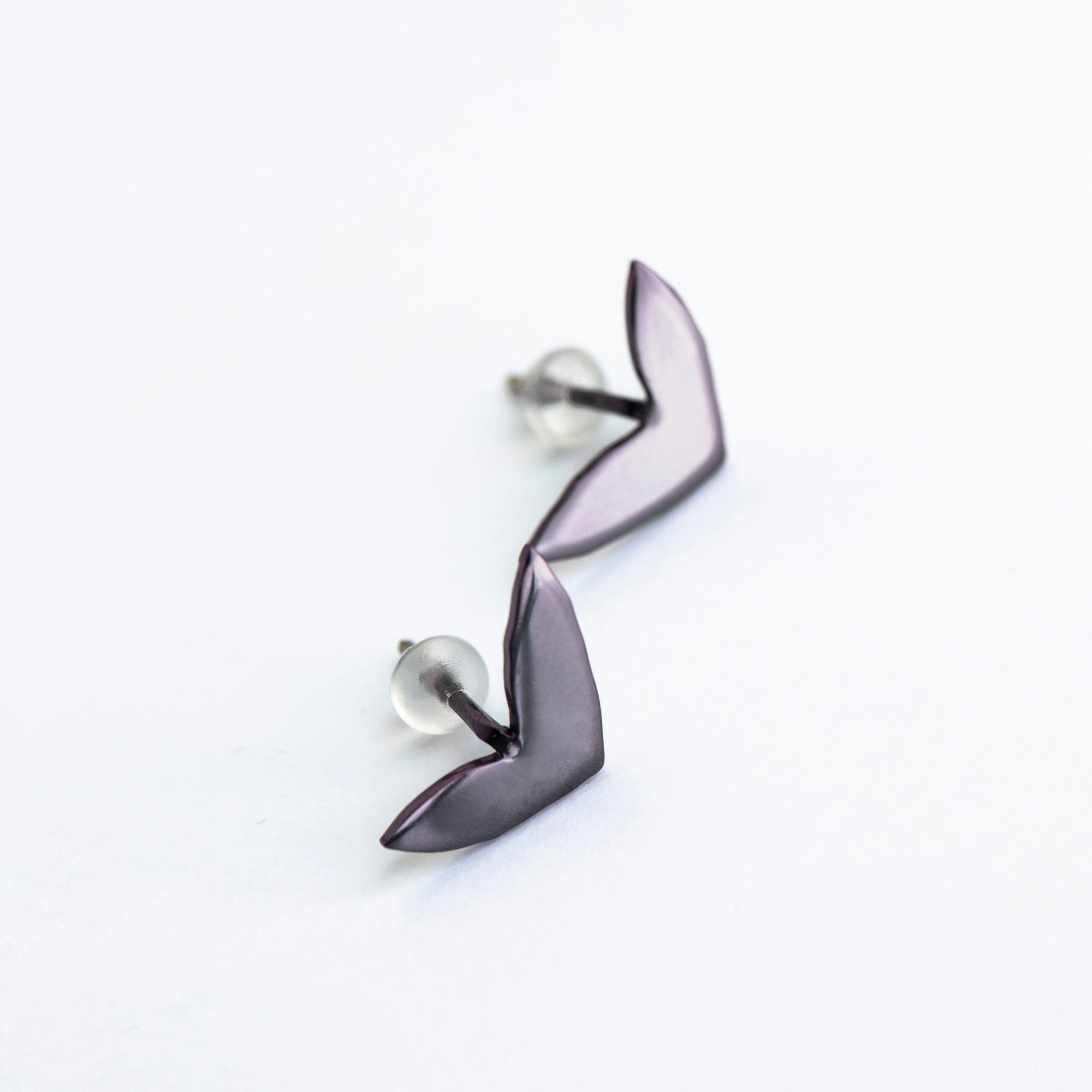 7. Studio shot of Lentsius Vola purple earrings with silicone stoppers, crafted from upcycled materials