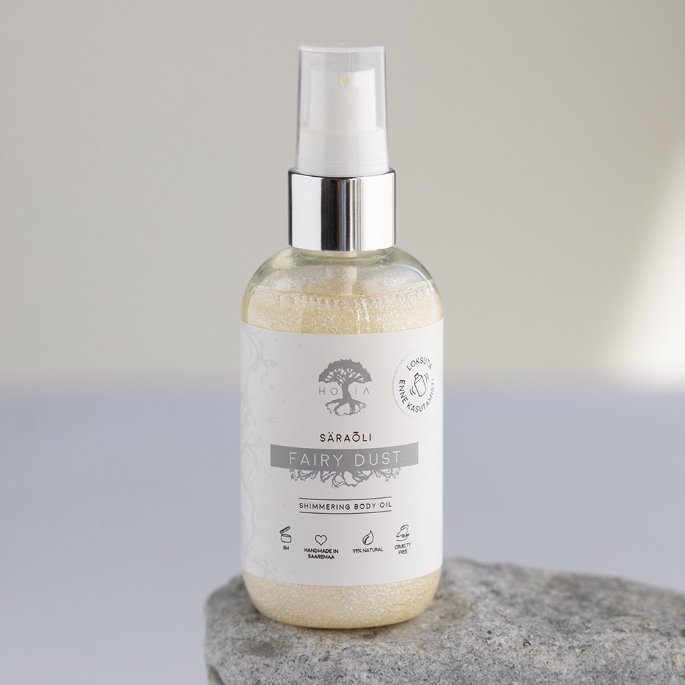 1. HOIA homespa Shimmering Body Oil Fairy Dust, 100ml bottle with silver mineral glitter, shown on a stone surface