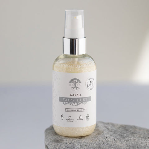 1. HOIA homespa Shimmering Body Oil Fairy Dust, 100ml bottle with silver mineral glitter, shown on a stone surface