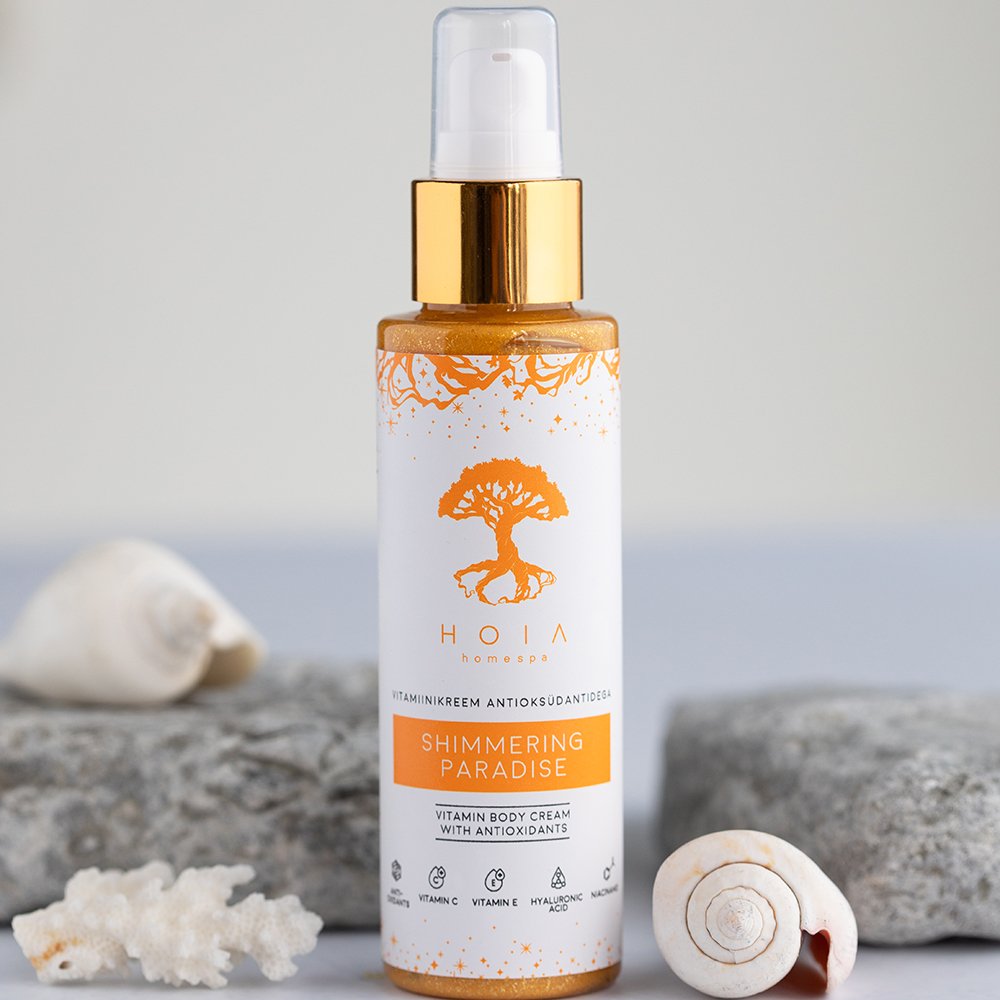 1. HOIA homespa Shimmering Paradise Vitamin Body Cream with Antioxidants, 100ml bottle displayed with seashells and stones