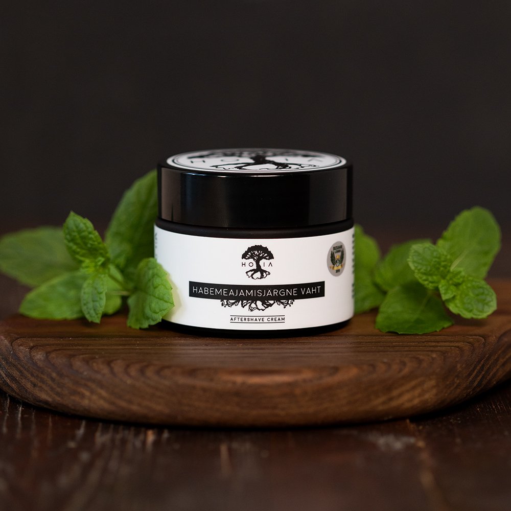 1. HOIA homespa men's aftershave foam in 50ML jar with peppermint leaves, showcasing natural and organic ingredients, antibacterial and anti-aging properties, on a wooden surface