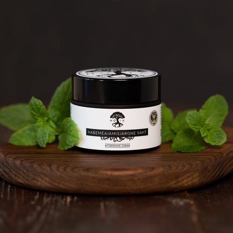 1. HOIA homespa men's aftershave foam in 50ML jar with peppermint leaves, showcasing natural and organic ingredients, antibacterial and anti-aging properties, on a wooden surface