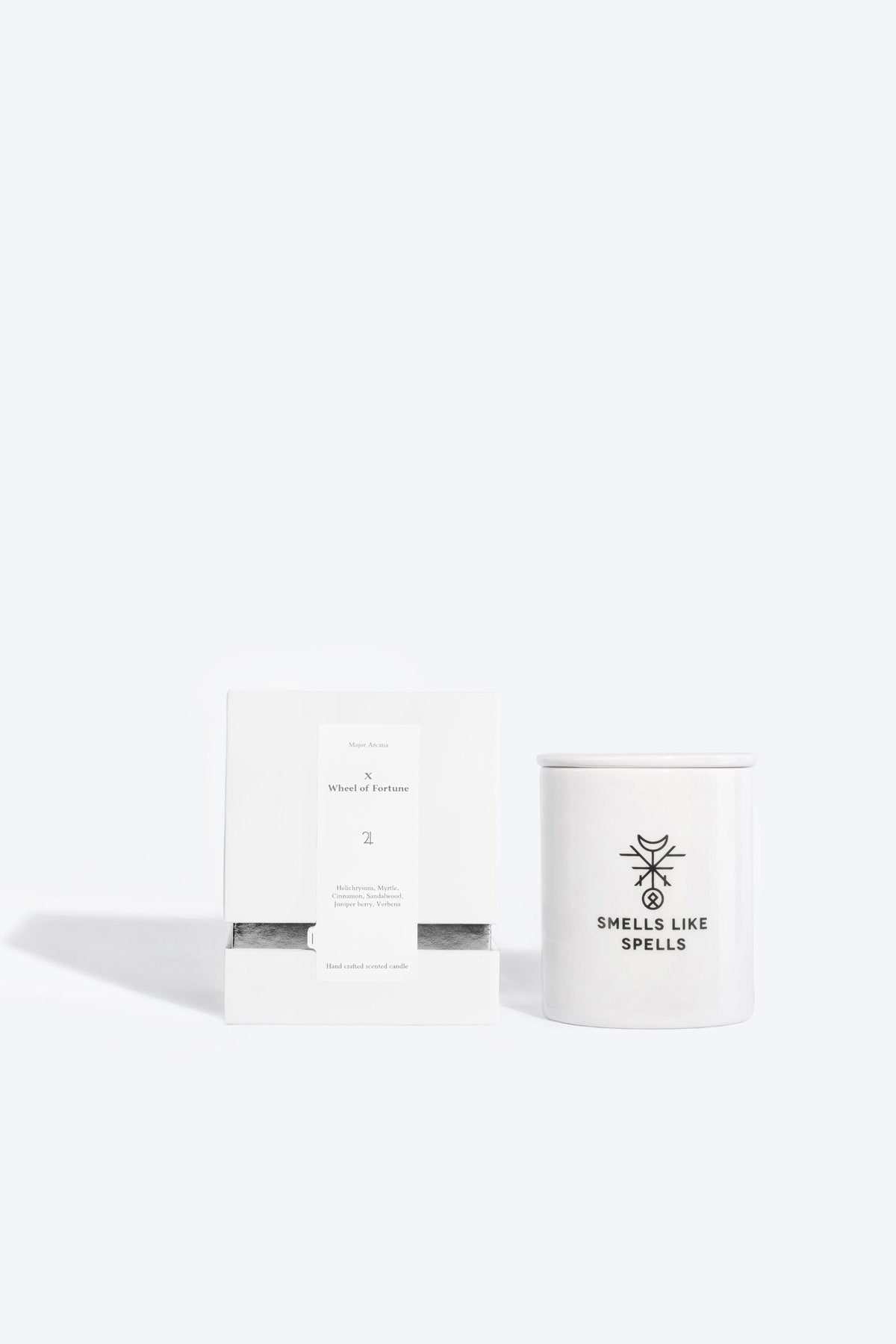 1. Smells Like Spells scented candle THE WHEEL OF FORTUNE with packaging, featuring hand-made porcelain container and tarot card, studio setting