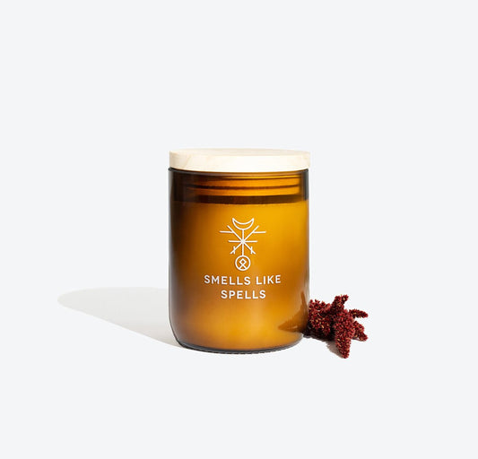 1. Smells Like Spells Scented Candle FREYR in amber glass jar with wooden lid, shown with decorative element