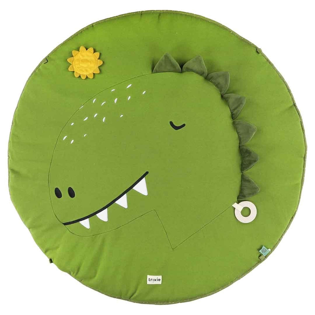 3. Close-up of green dinosaur face on play mat with textured sun and wooden ring, highlighting playful design