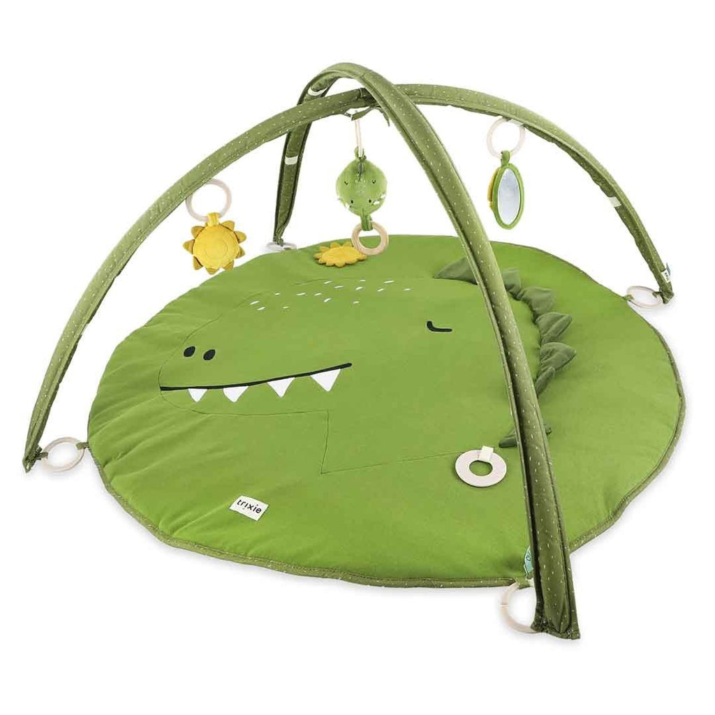 1. Green dinosaur-themed activity play mat with two arches and hanging toys including a mirror and teether, made from organic cotton by Trixie Baby