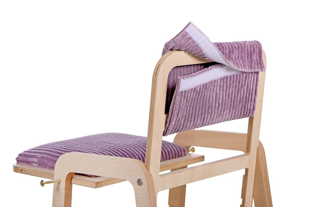 15. Child engaging with Luula Julle table in cannon pink, highlighting interactive features