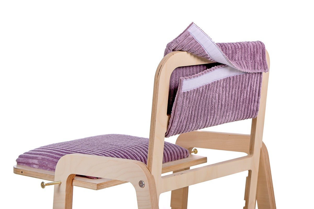 15. Child engaging with Luula Julle table in cannon pink, highlighting interactive features