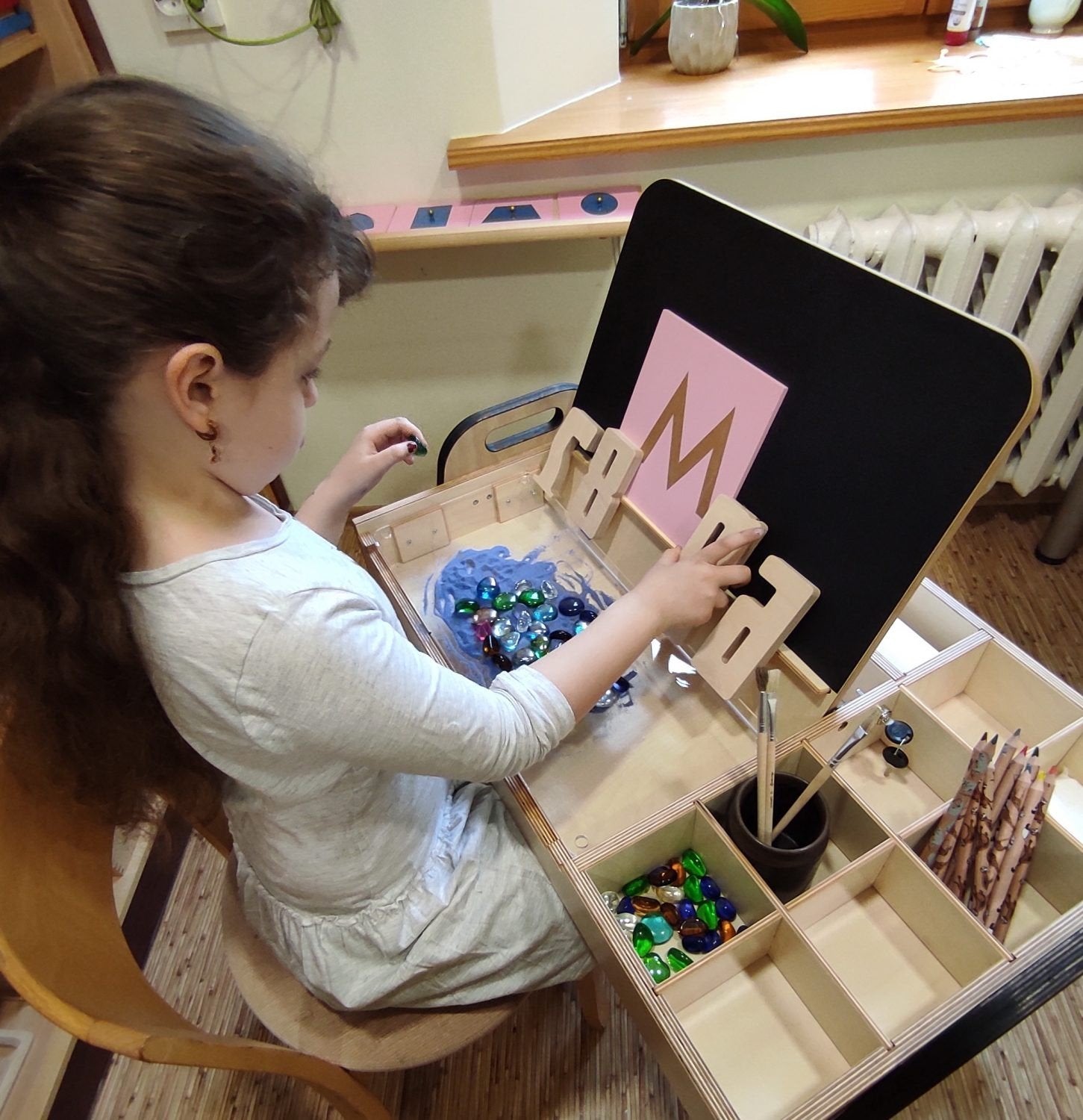 14. Detail of Luula Julle table with organized storage for pencils and art supplies