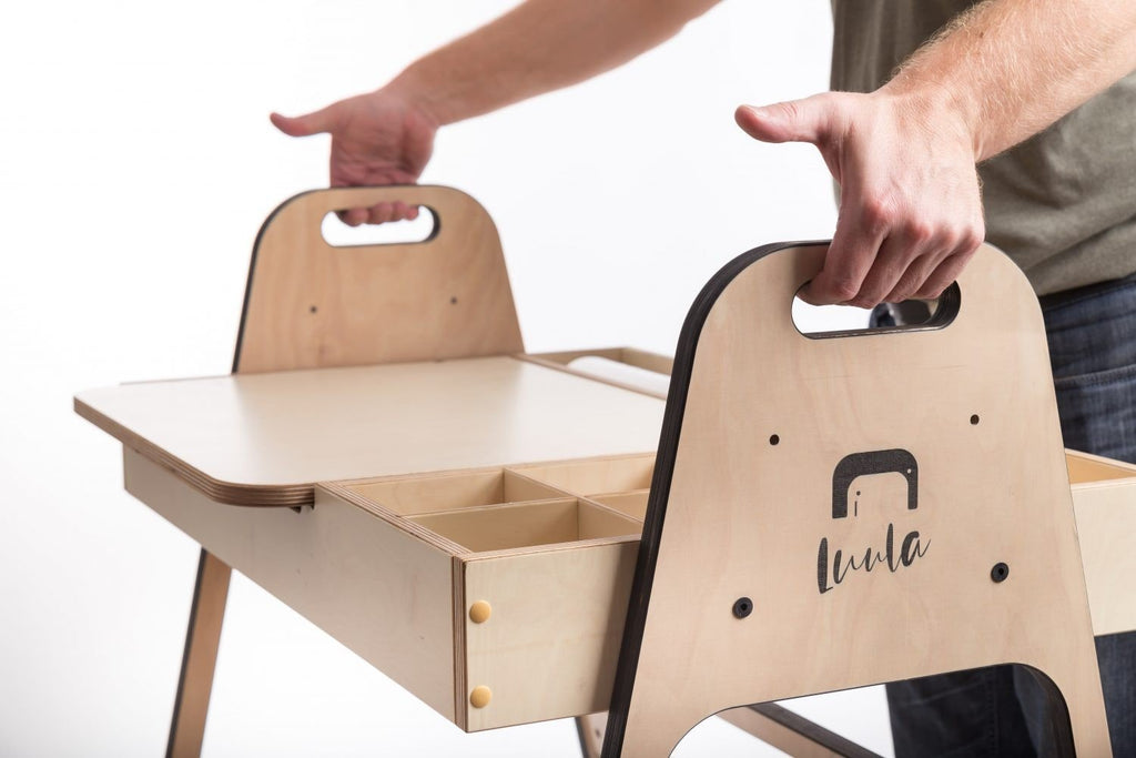 3. Close-up of hands lifting the table lid showing storage compartments