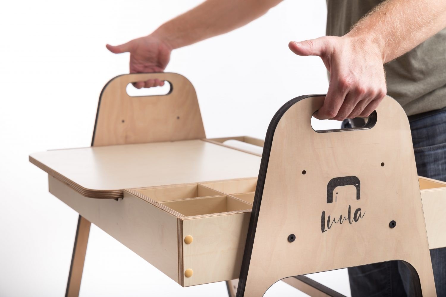 3. Close-up of hands lifting the table lid showing storage compartments