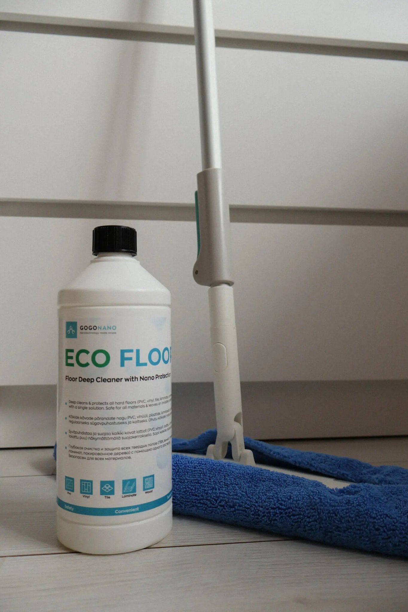 1. GoGoNano EcoFloor natural floor cleaner 1L bottle next to a mop on a wooden floor