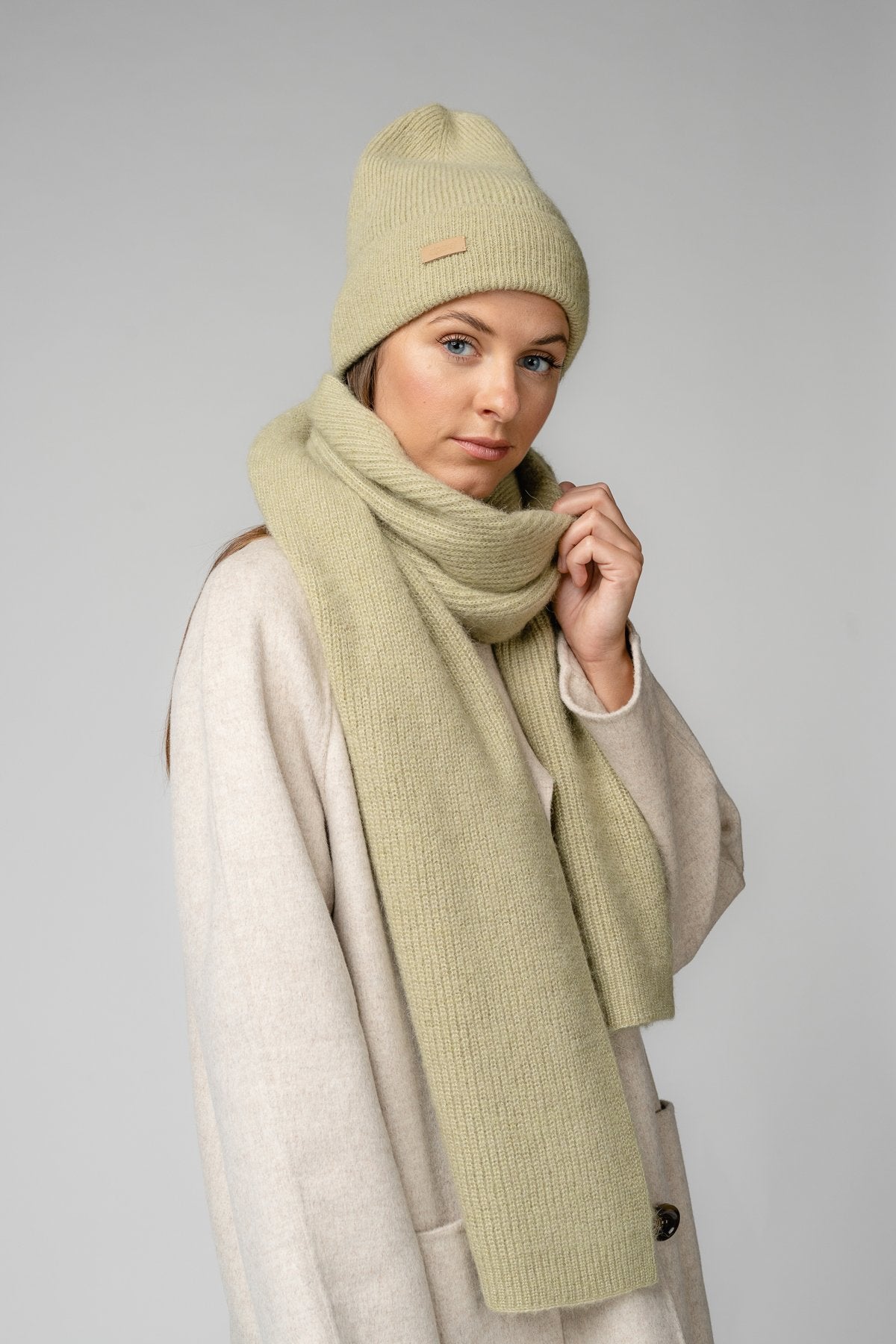 14. Women's musk green Alpaka Fisherman's Rib scarf and hat shown in side view