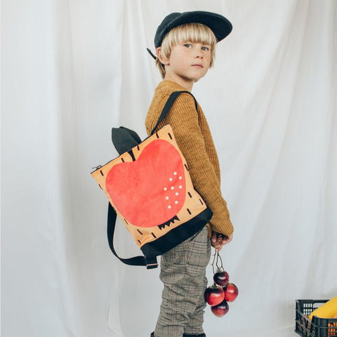 4. Studio image of Muni apple backpack for kids, featuring bright apple motif and sturdy design
