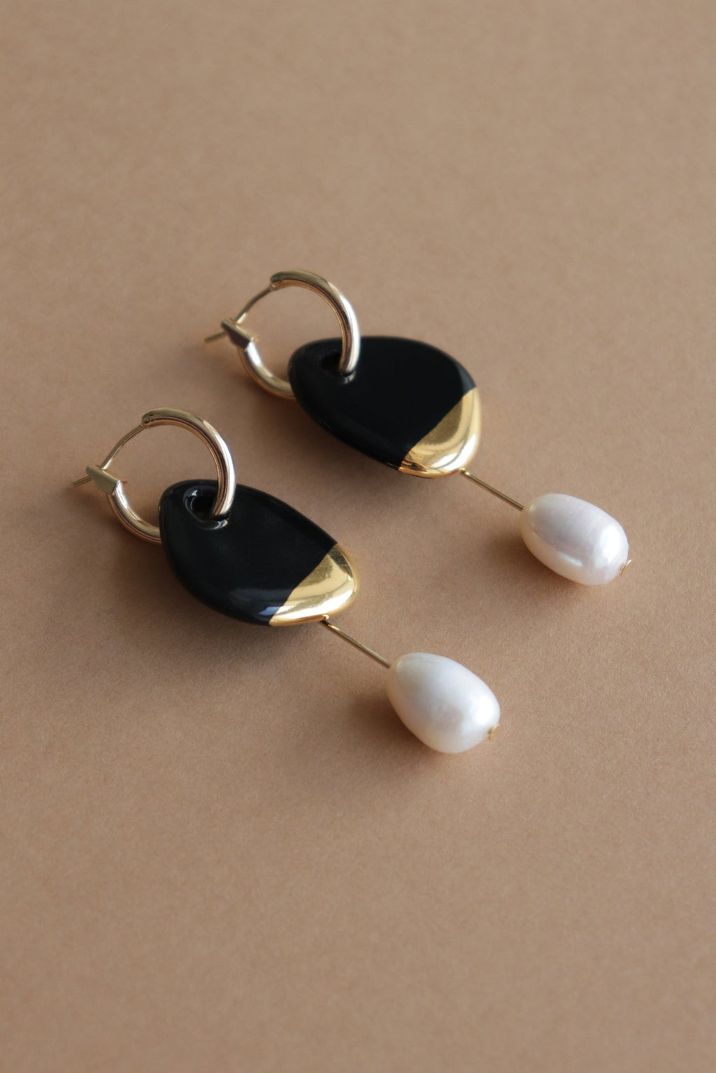 4. Rozenthal Arp Pearl and Porcelain Earrings in black on brown background, showing mix and match elements