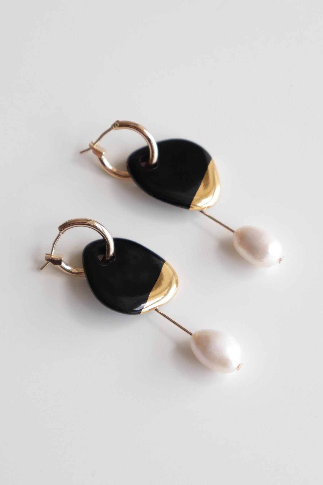 3. Rozenthal Arp Pearl and Porcelain Earrings in black with gold-plated hoops and freshwater pearls